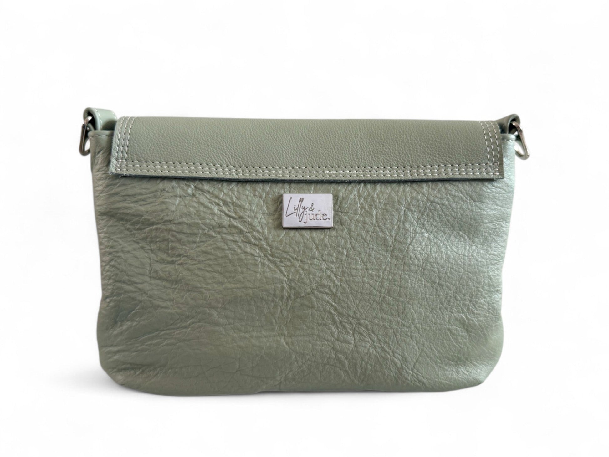 The image shows the back view of the pale sage green, Olivia crossbody bag. It shows the soft, wrinkled texture of the gorgeous genuine leather, which was rescued from heading to landfill. It is a one-off and exclusive to Lilly & Jude