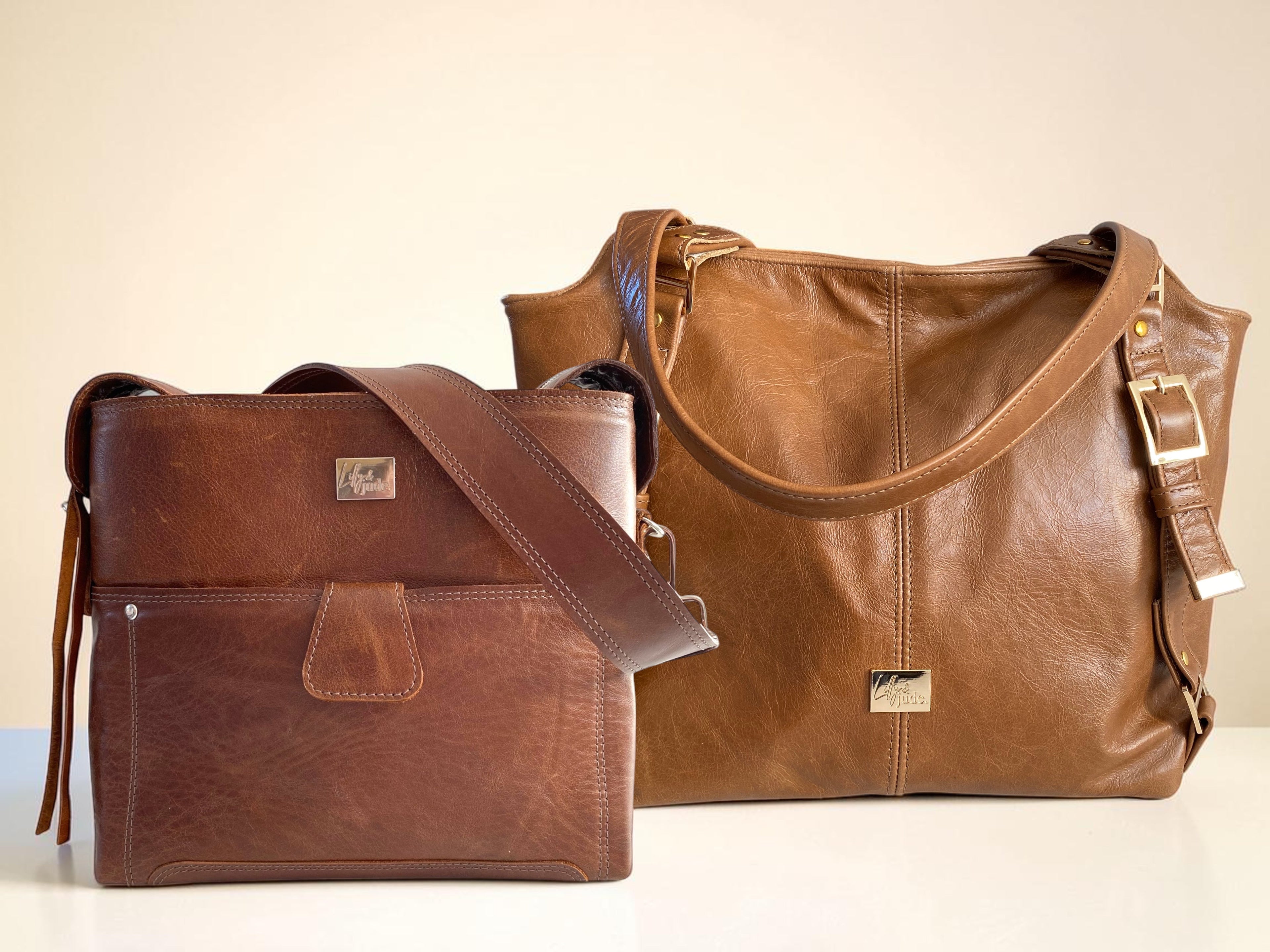 A chestnut brown leather handbag and a tan leather slouch bag on a neutral background