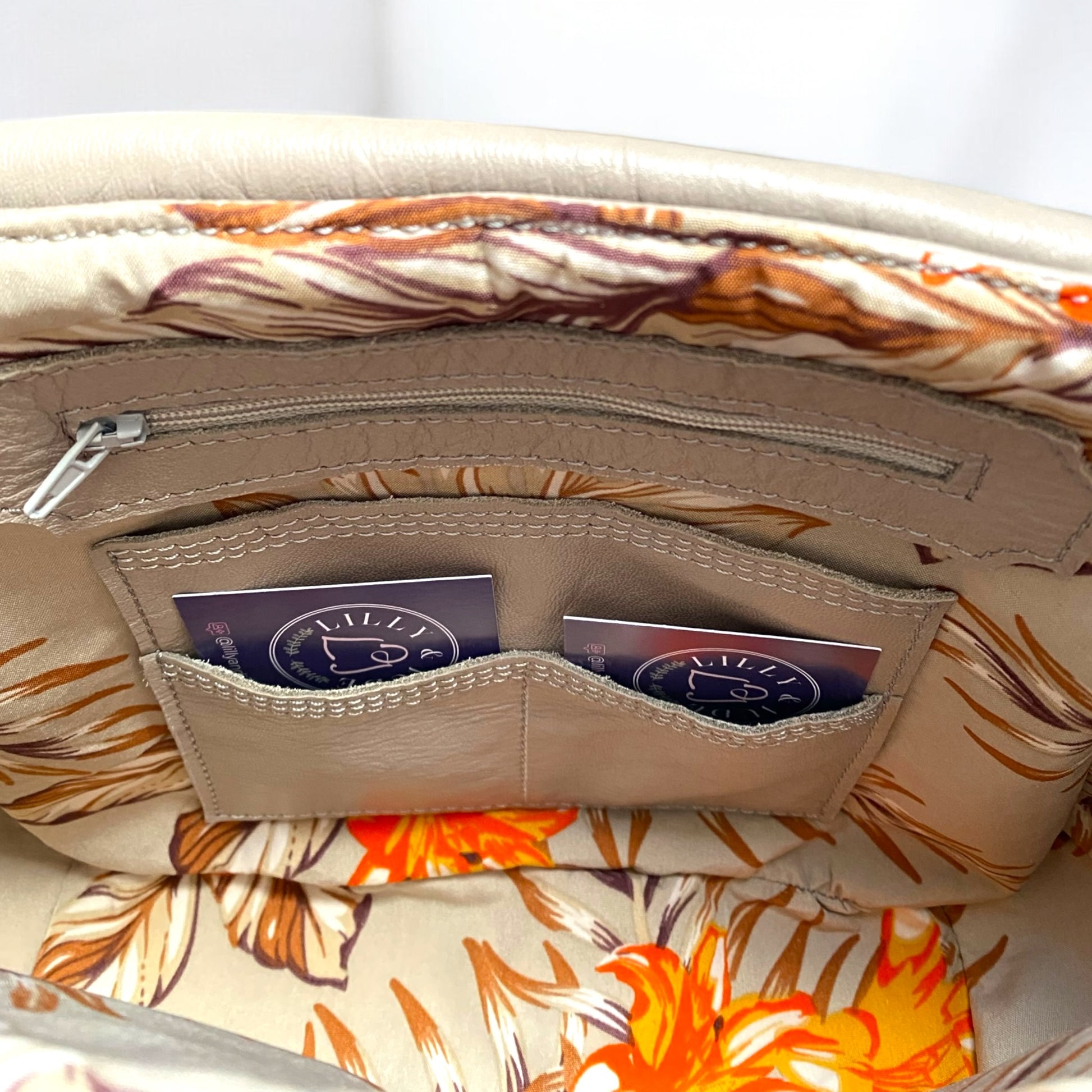 image shows the interior details of a bag. There's an inbuilt, integrated purse that has space for bank cards, a slip pocket and a zipper pocket