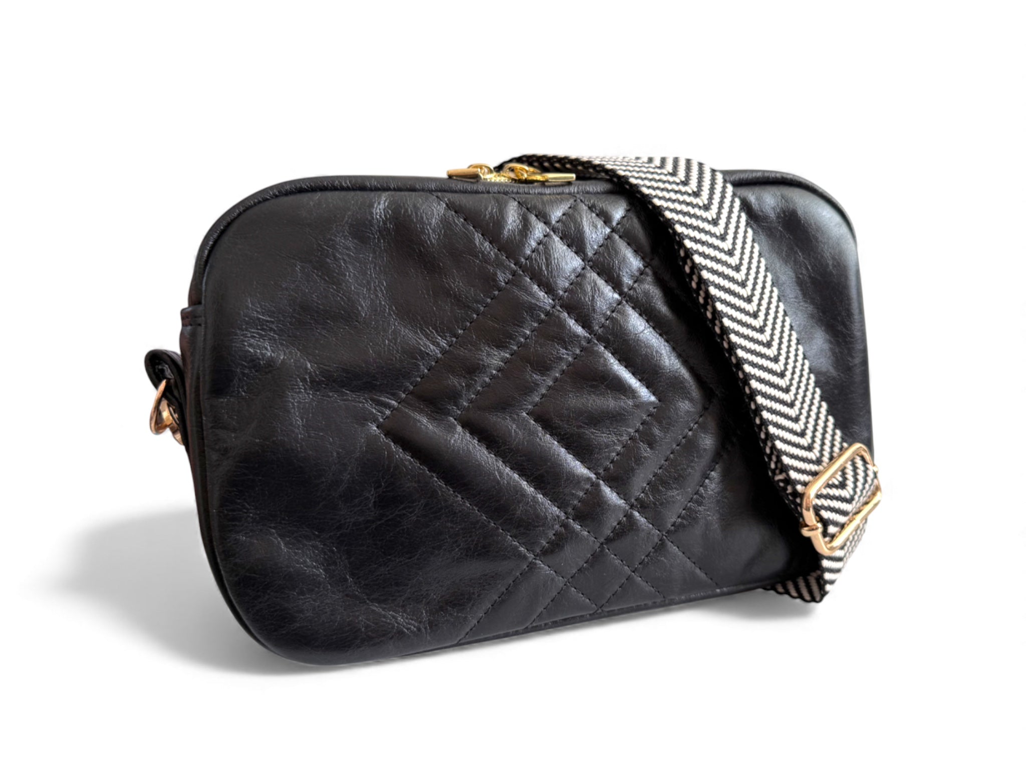 Black Catalina, leather quilted crossbody bag with a patterned strap on a white background