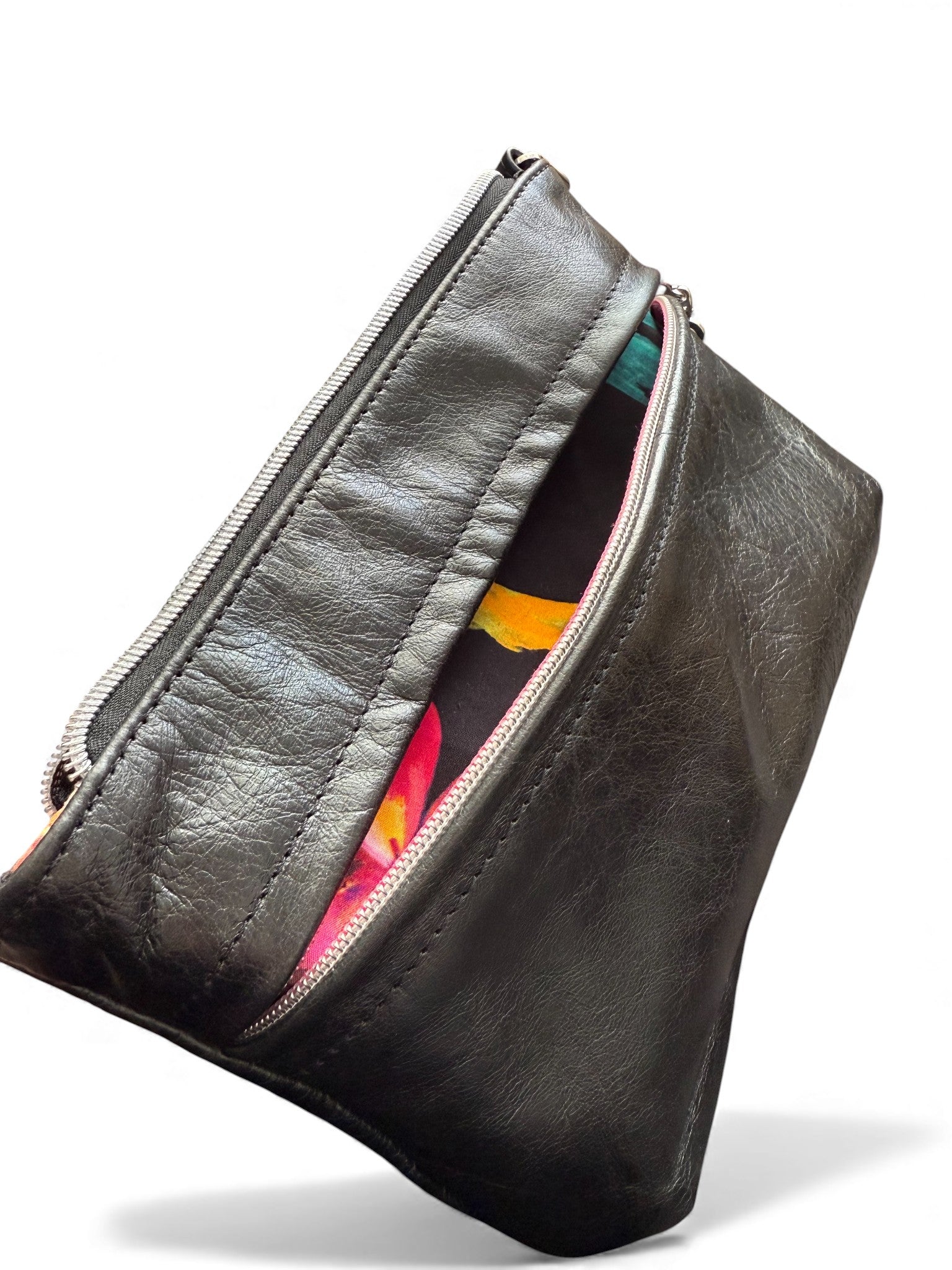 Black leather pouch with colorful interior on a white background