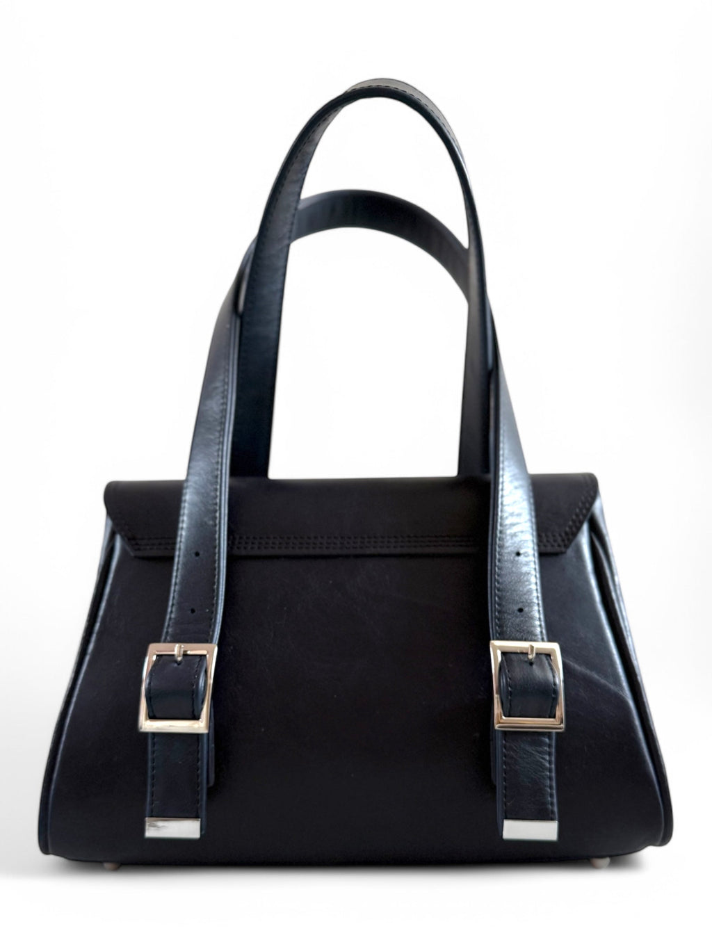 Navy blue leather handbag with blue straps on a white background