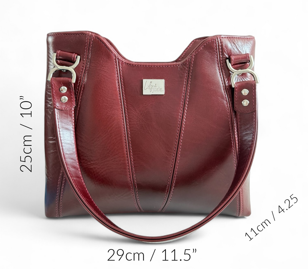 Burgundy leather Alaula handbag with measurements on a white background