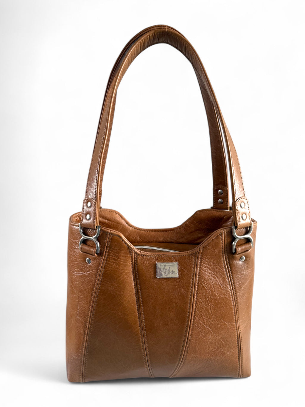 A tan leather shoulder bag with double handles, silver hardware, and a structured shape.