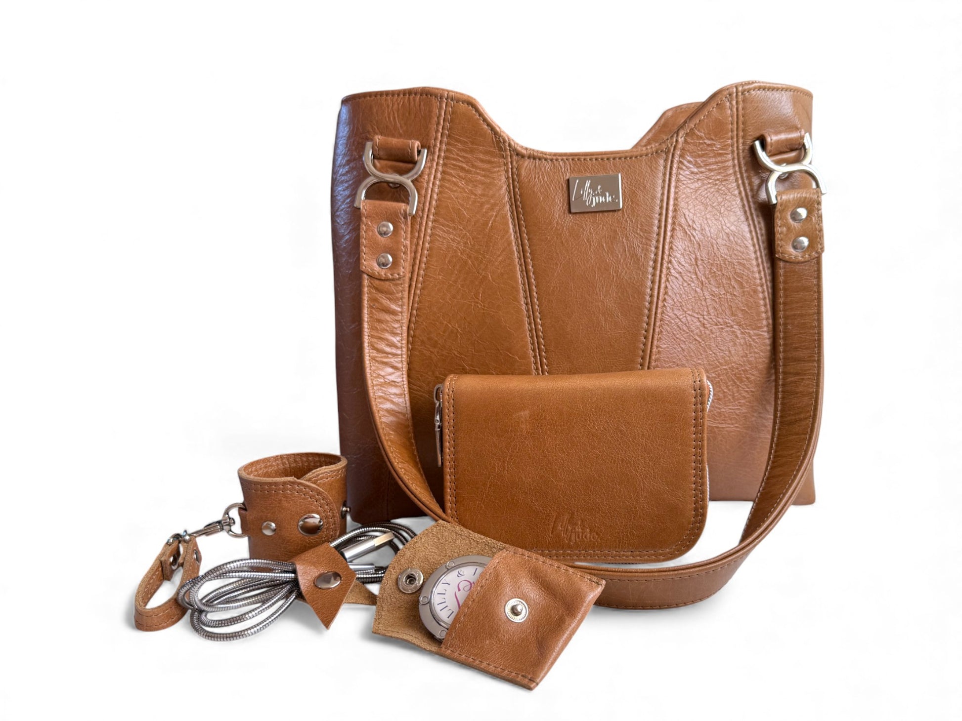 Brown leather handbag with matching wallet / purse, scarf holder, cable keeper and bag hook in a matching pouch. Handcrafted from tan rescued leather, this gift set is limited to 1 and is exclusive to Lilly & Jude