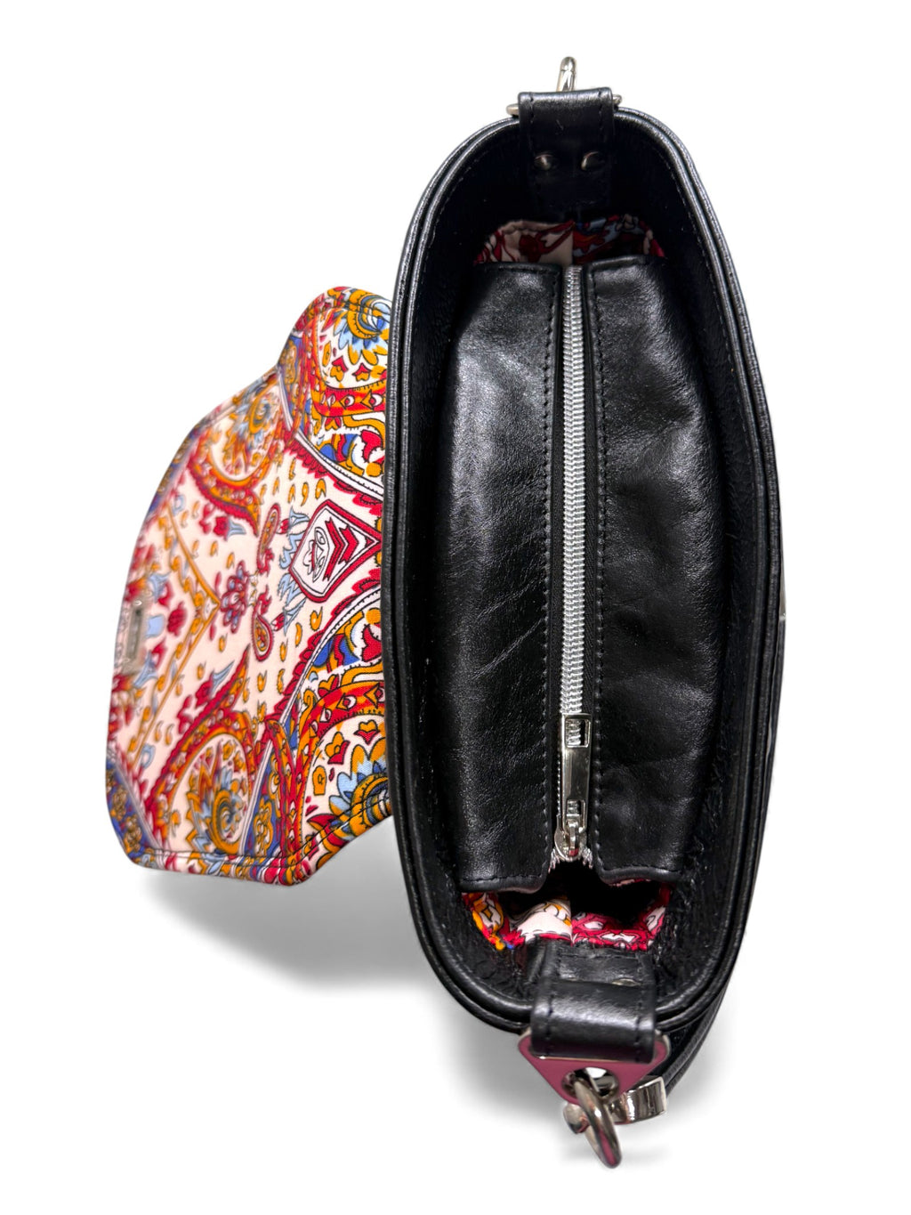 Top view of the Belle handbag. The flap is open, showing off the stunning lining and the silver zipper opening . The bag is on a white background and is a limited edition of 1.