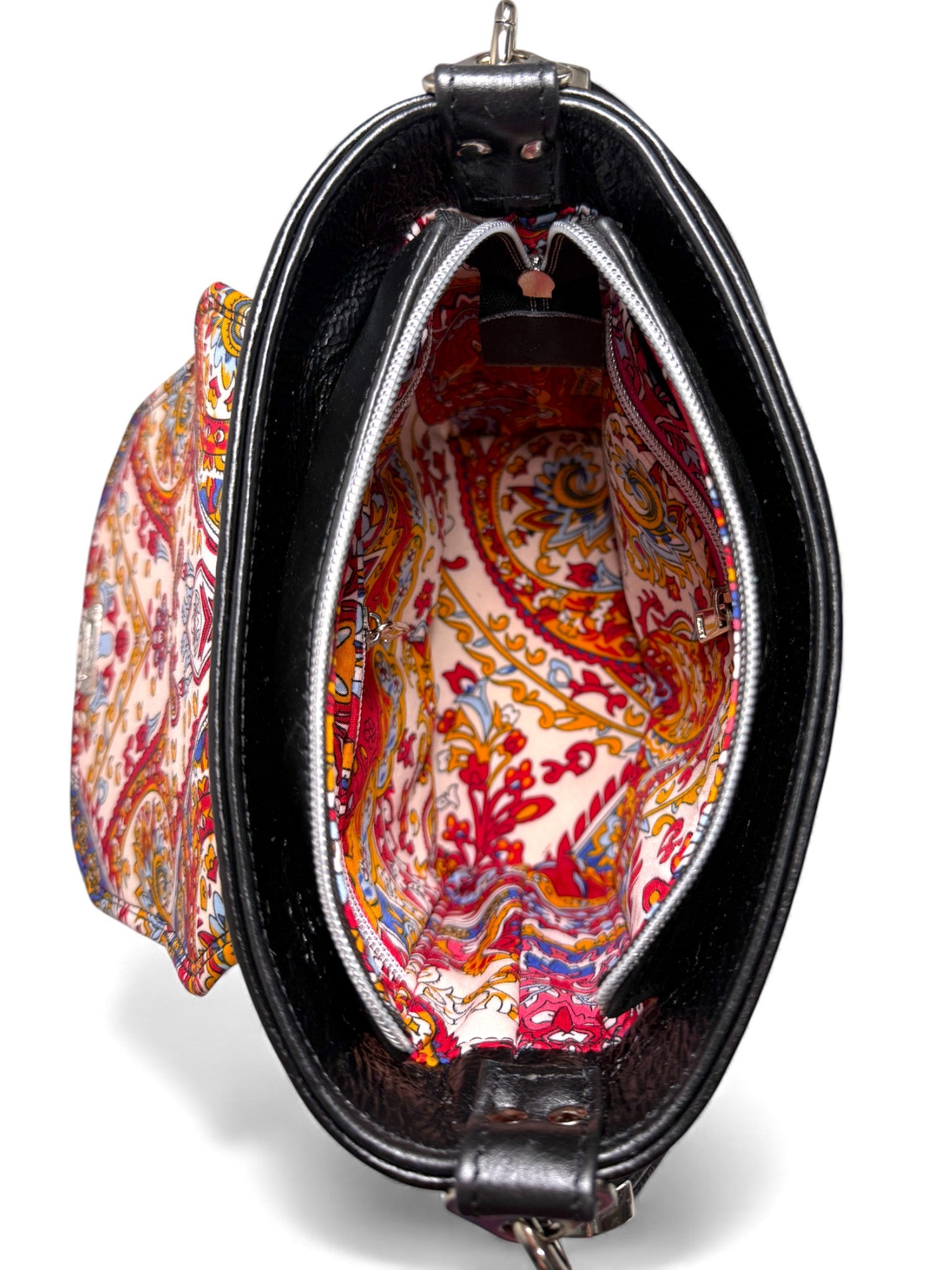 Top view of the Belle handbag. The bag zipper is open, to reveal the beautiful, colourful patterned lining. Designer handbag by Lilly & Jude