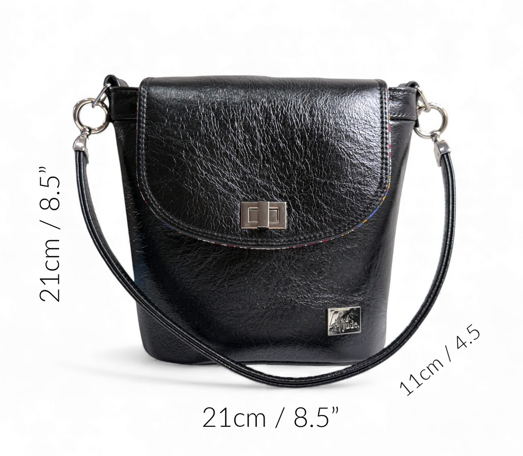 Belle bucket bag in black leather that was rescued from heading to landfill, sat on a white background, with the dimensions of the bag around the edge of the image