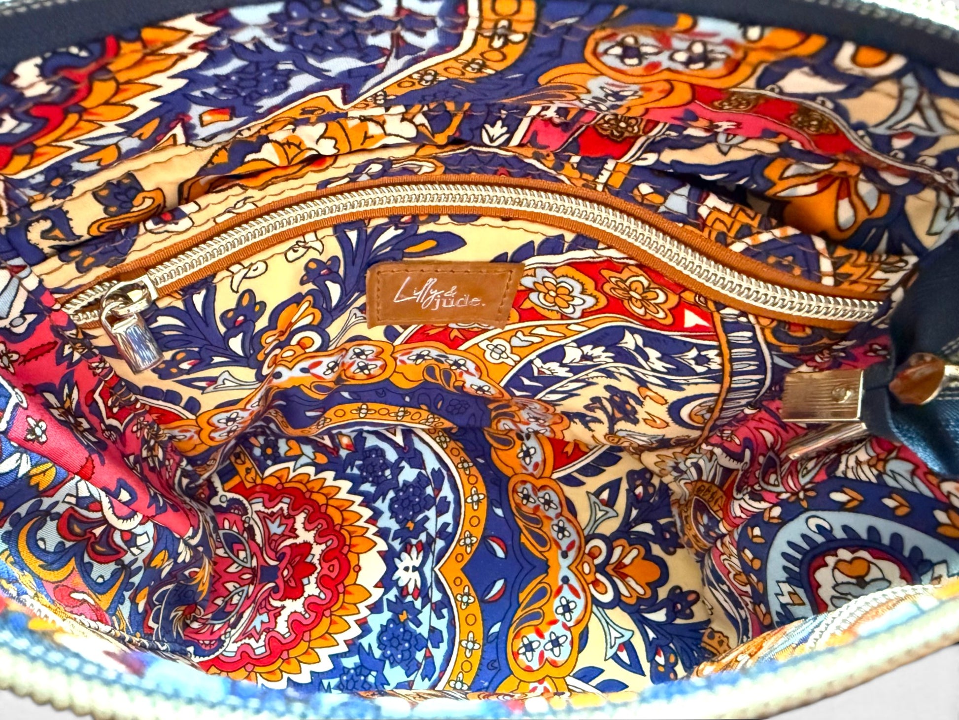 Colorful patterned lining with a visible brand Lilly & Jude logo on a white background