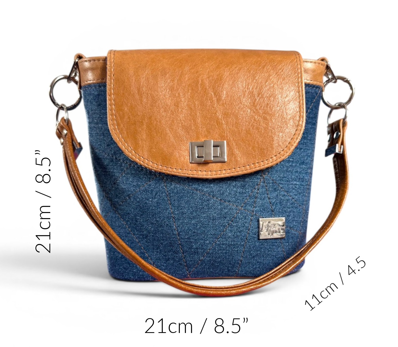 Blue denim and tan brown bucket bag with measurements on a white background