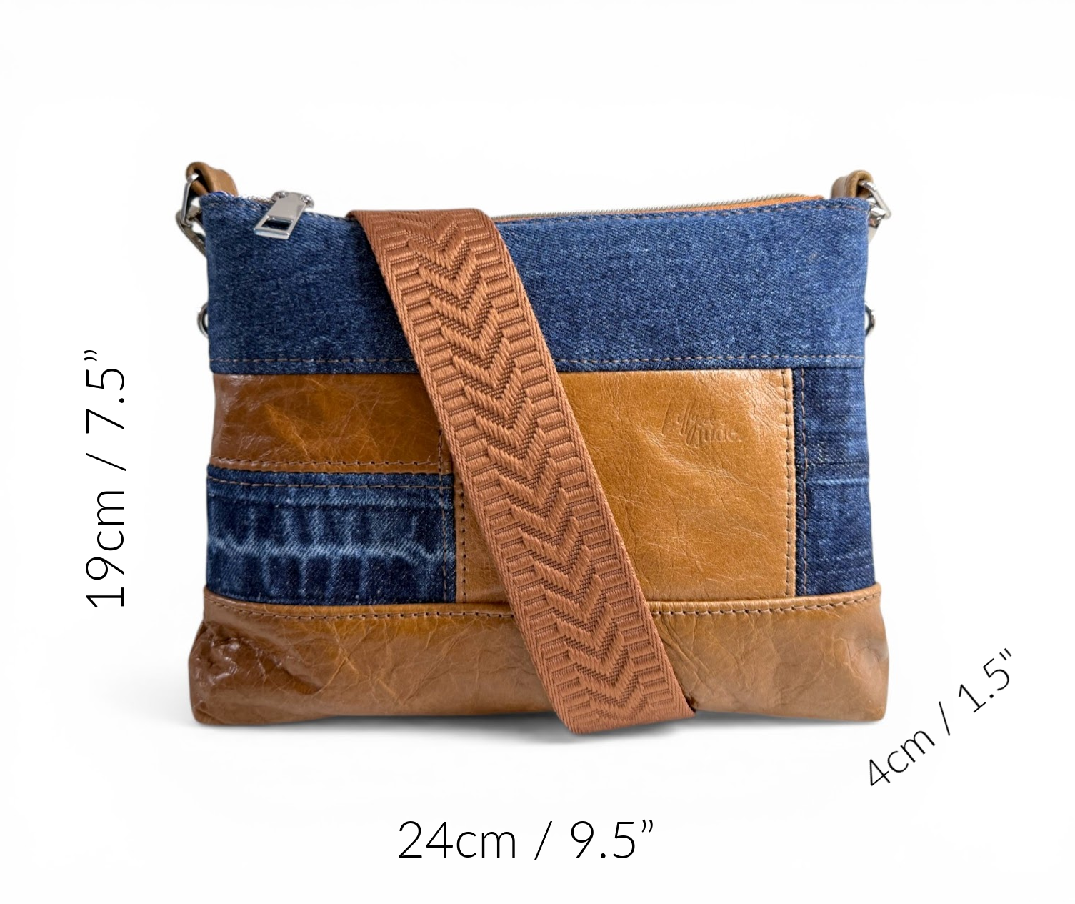 Denim and tan brown leather crossbody bag with measurements on a white background