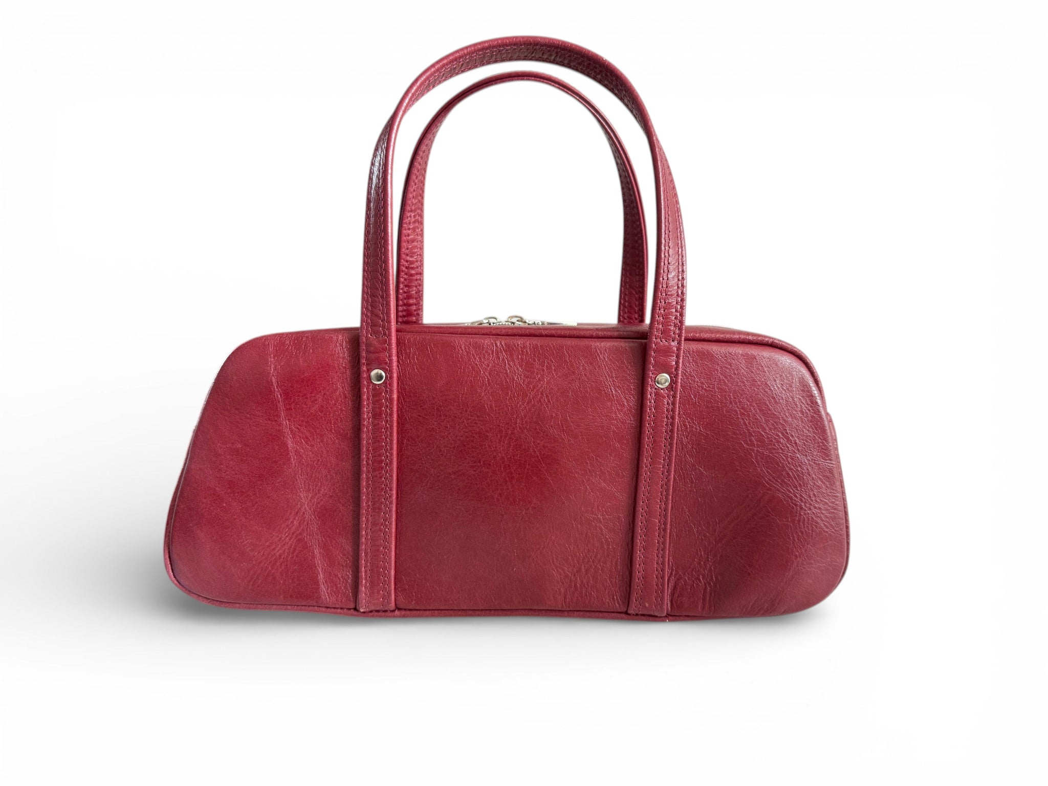 View of the back of the red rescued leather Cassie bowling bag, against a white background