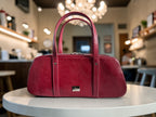 Red handbag on a table with a blurred background