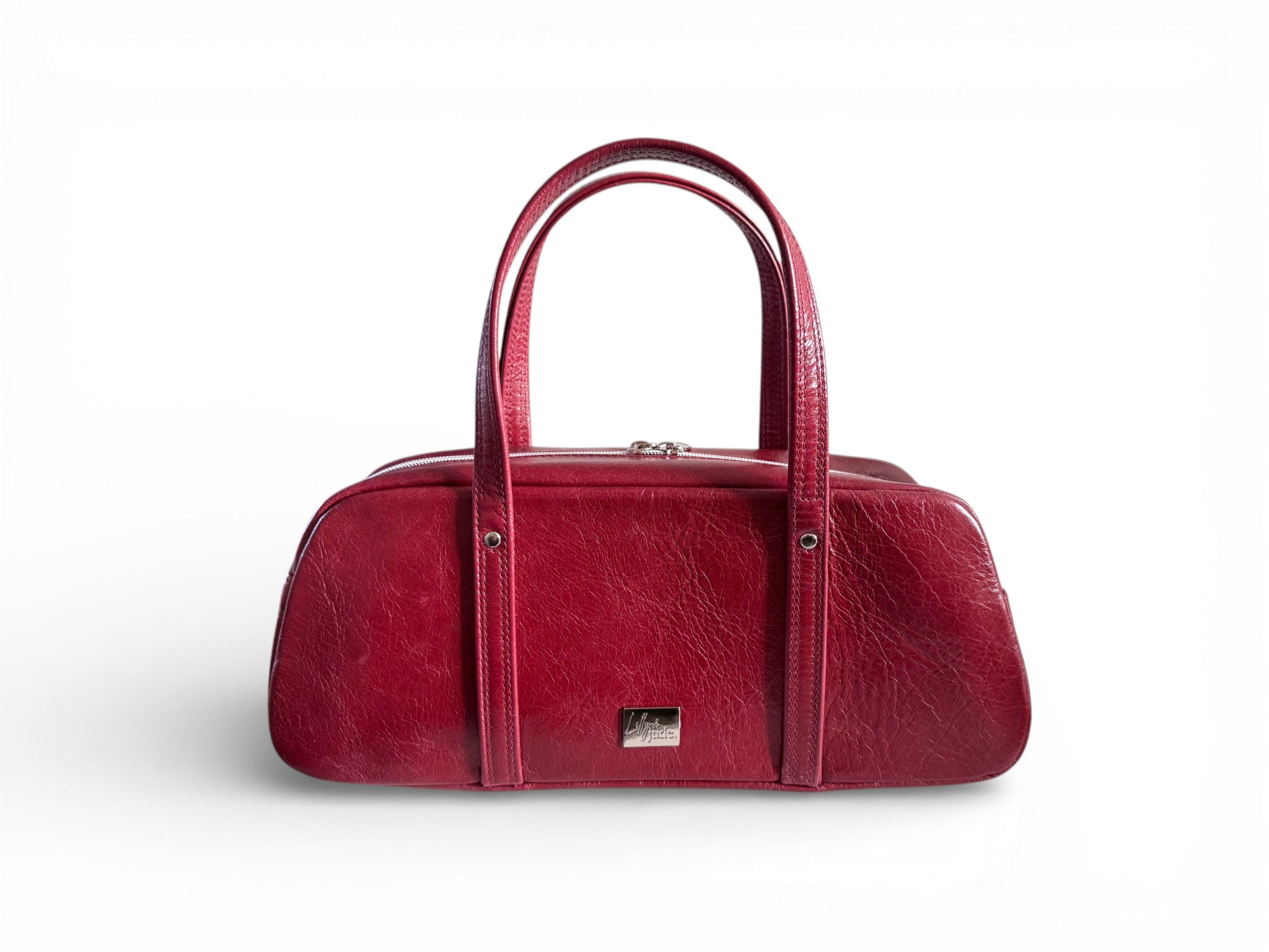 Red leather, baguette style handbag on a white background