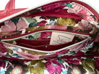 Floral-patterned lining handbag, showing the zip/slip and hidden integrated purse with a visible brand label.