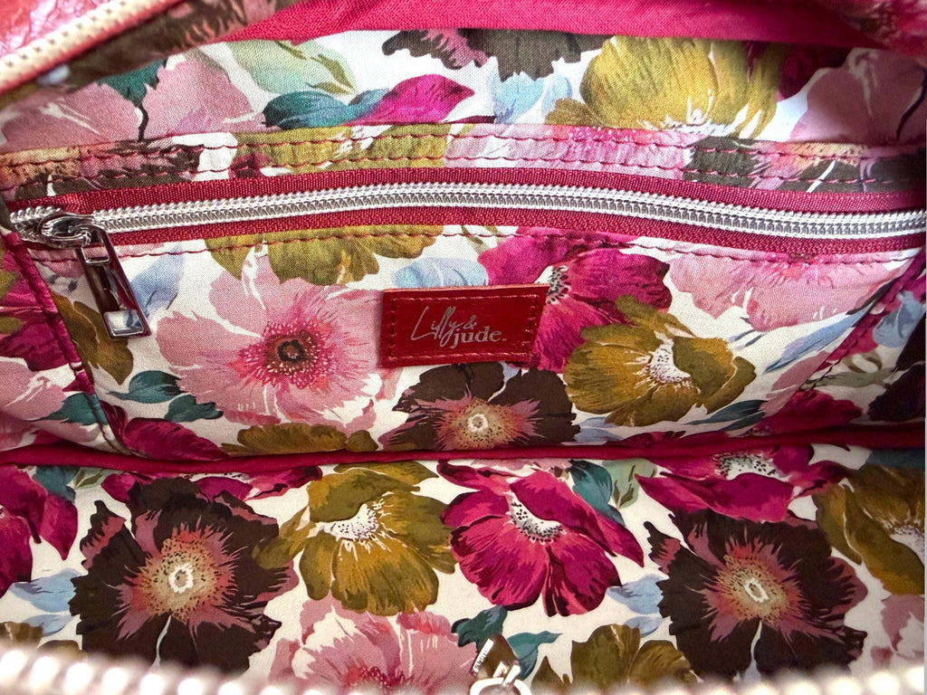 Interior view of the Cassie bag, showing the floral-patterned lining with a visible brand label on a slip/zip pocket