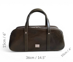 Deep green leather duffel bag with dimensions indicated on a white background