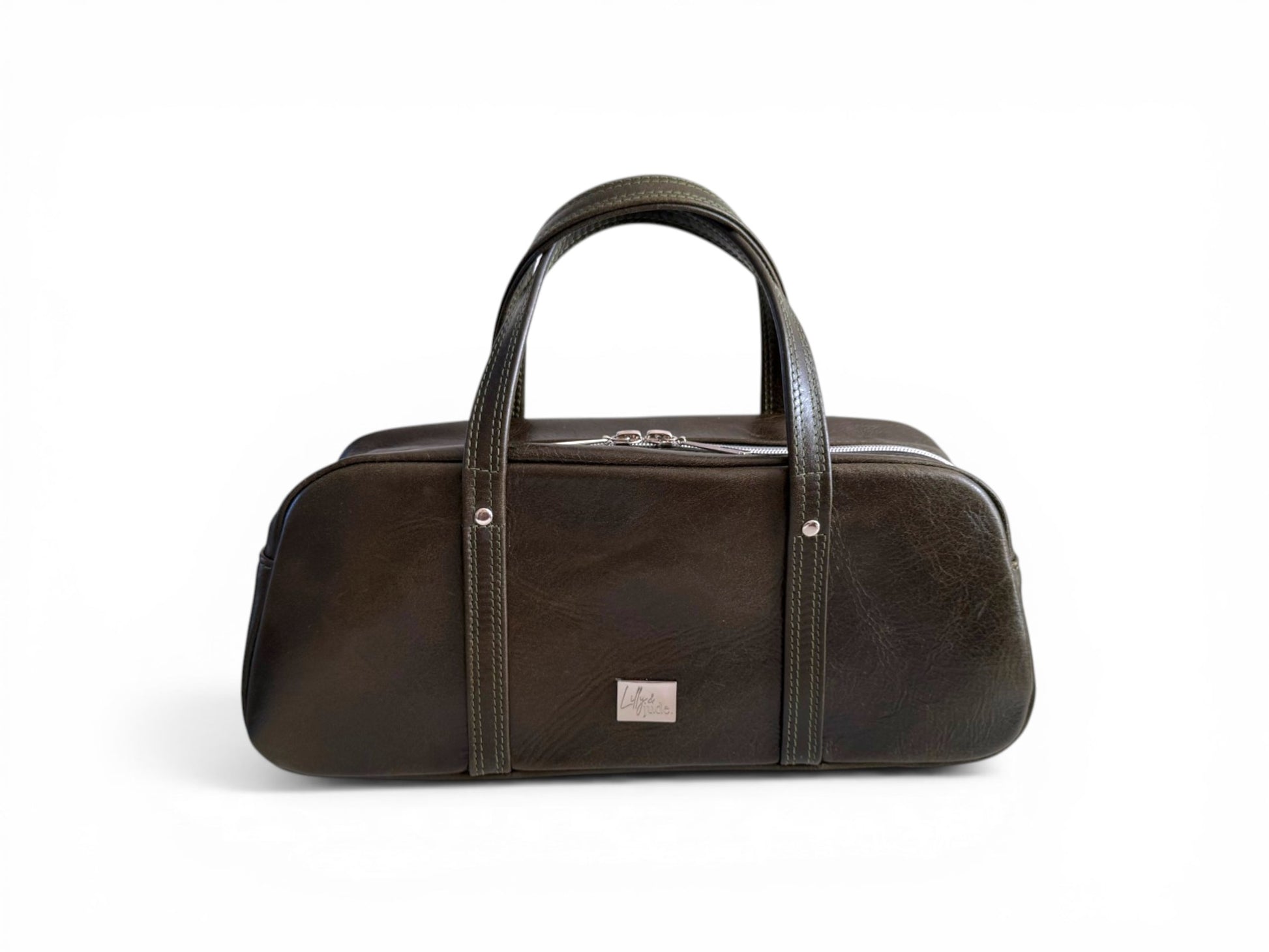 Dark green leather bowling style bag with silver hardware, against a white background