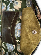 Close up of the interior of the Cassie bowling bag, showing the green floral lining and a Lilly & Jude integrated purse 