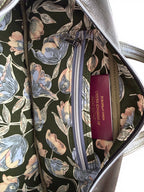 Floral-patterned bag lining with a visible slip/zip pocket, with a passport stored neatly in the slip pocket,  on a white background