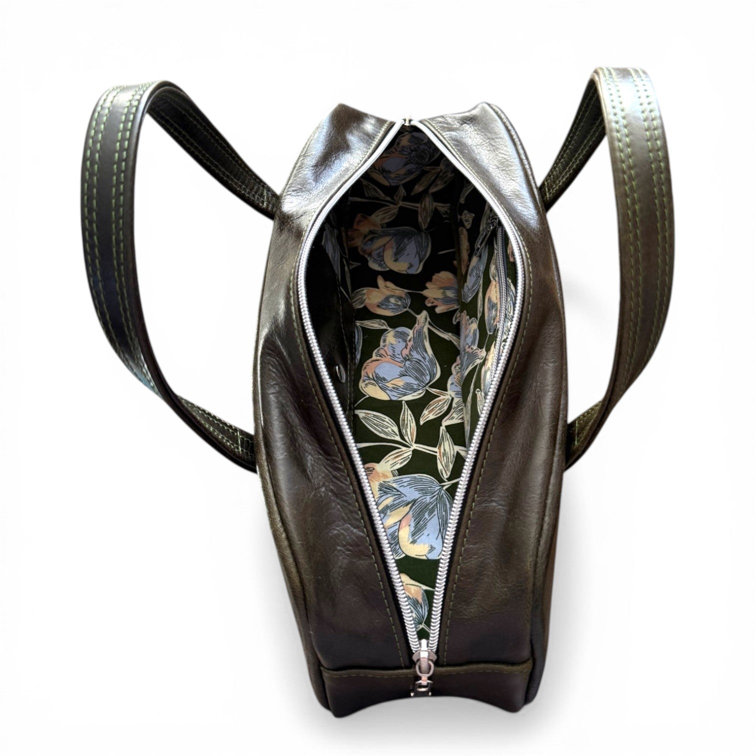 Birds eye view of the open Cassie bowling bag, showing the floral patterned lining inside