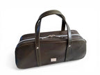 Dark green (almost black)  leather baguette style bowling bag, with silver hardware against a white background
