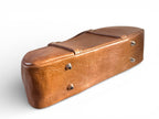 Bottom view of the base of a Tan brown coloured leather Cassie bowler bag, showing the silver bag feet at the base.