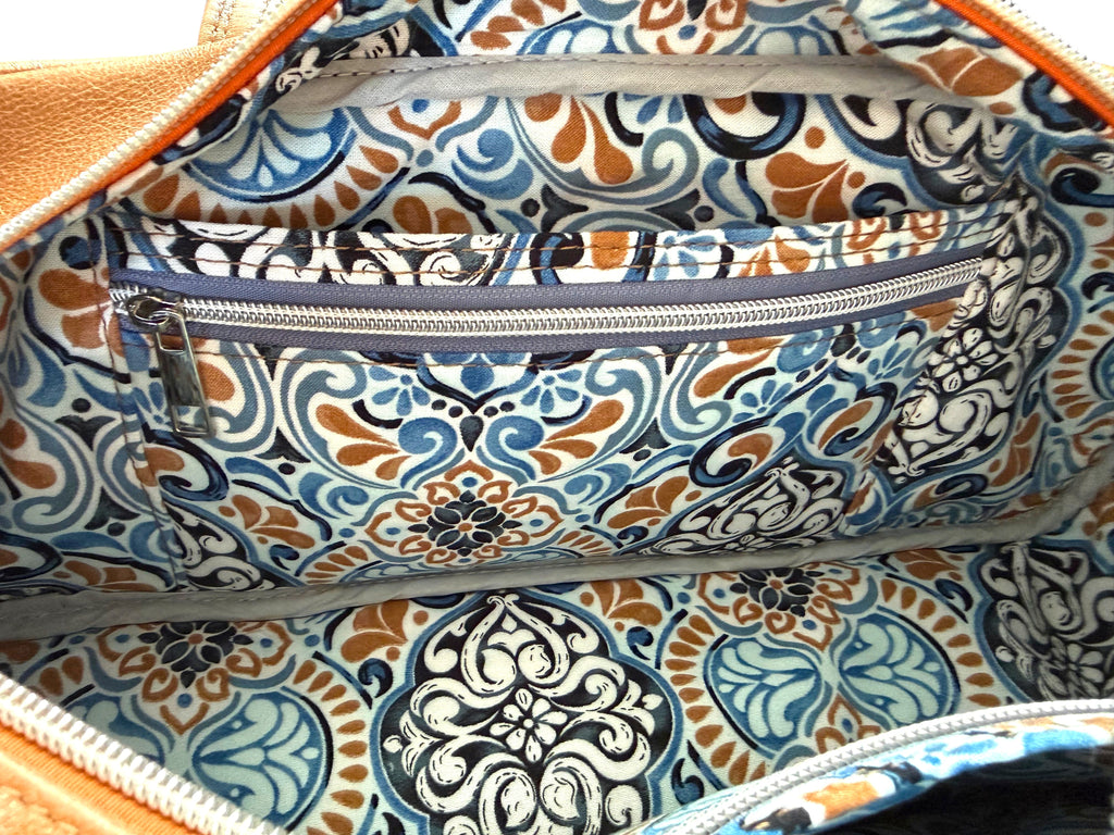 Patterned bag lining with slip and zip pockets on a matching fabric background