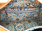 Patterned bag lining with slip and zip pockets on a matching fabric background