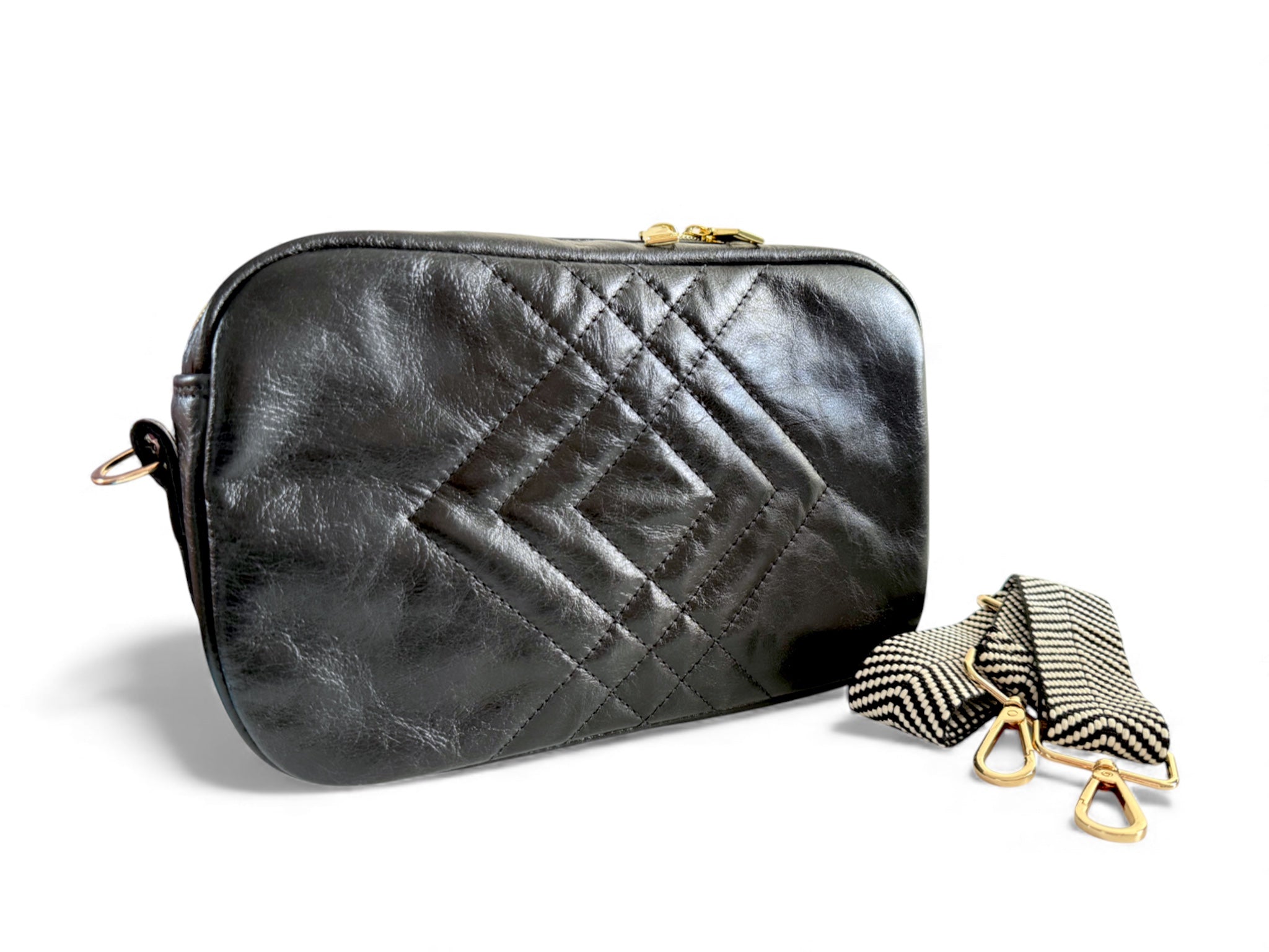 Black quilted handbag with a matching strap on a white background