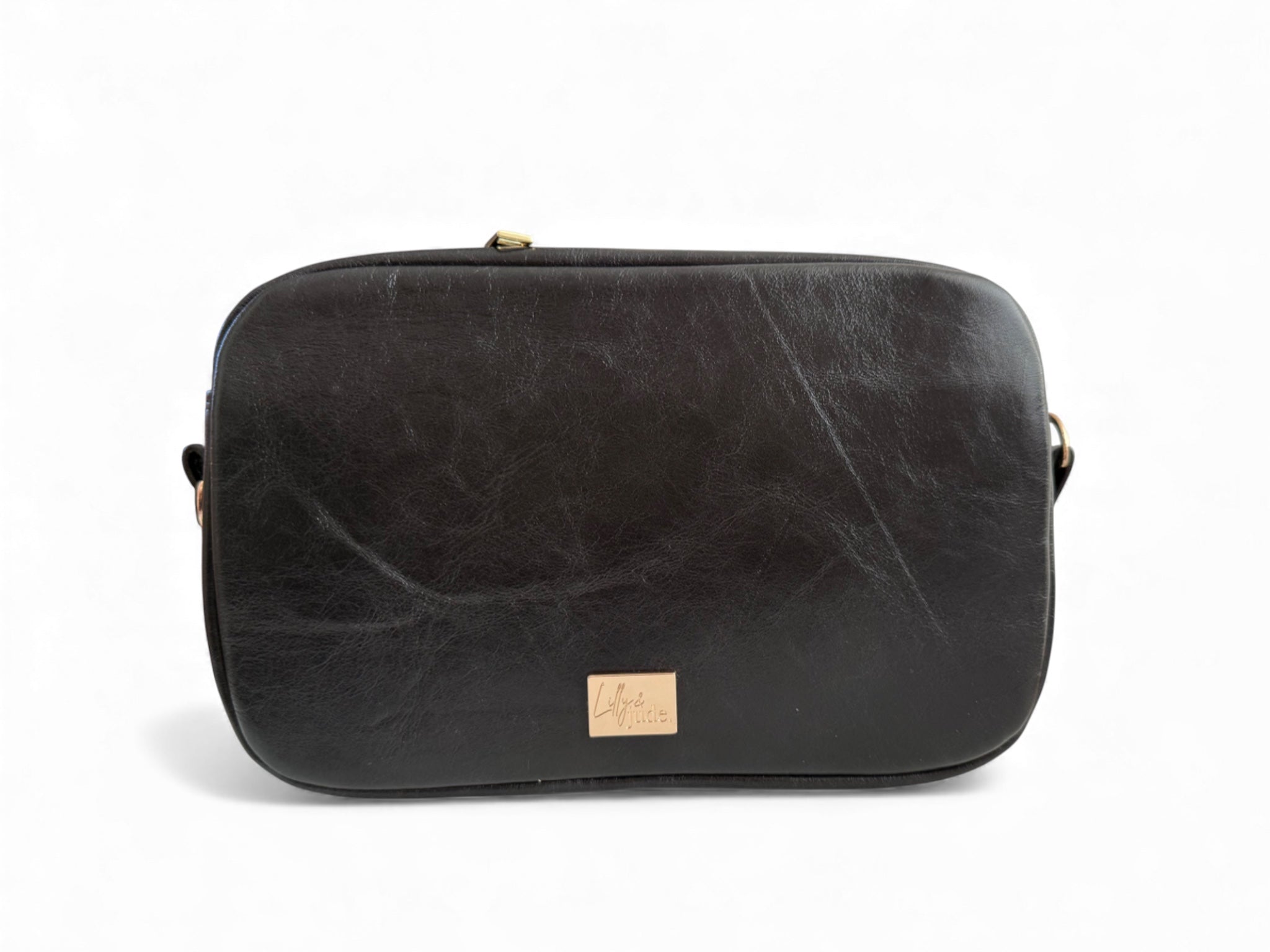 View of the back of the black Catalina crossbody bag with a visible brand logo on a white background. Handcrafted using rescued leather