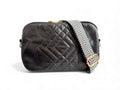 Black quilted leather handbag with a patterned strap on a white background