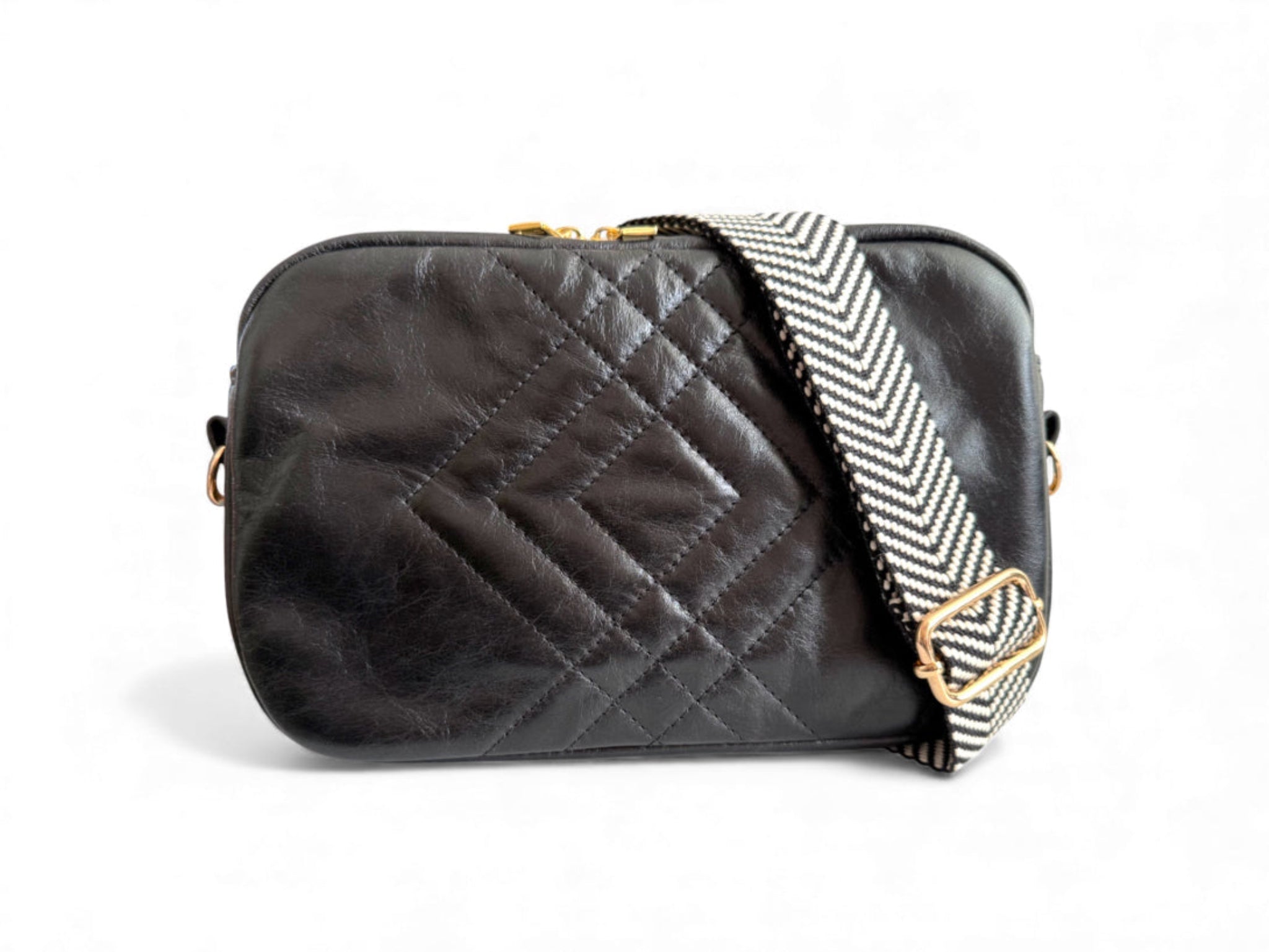 Black quilted leather handbag with a patterned strap on a white background