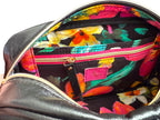 Interior view of the Catalina cross body bag. Showing the bright, floral-patterned interior  and view of the slip/zip pocket. Exclusive to Luilly & Jude