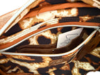 View of the interior of the brown leather Catalina bag, showing the leopard print lining and the slip/zip pocket open to reveal the integrated purse 