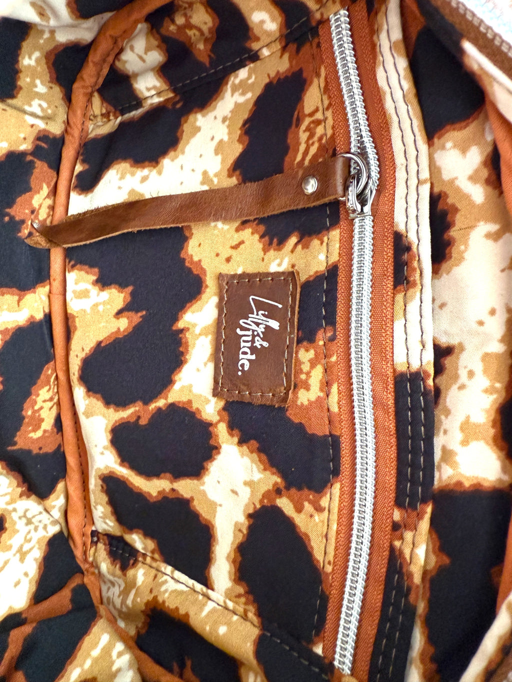 Interior view of the Catalina, showing the leopard print lining, with a visible brand logo on a close-up view