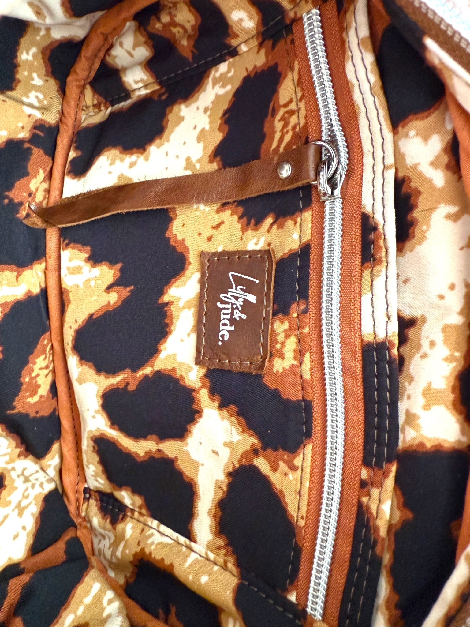 Interior view of the Catalina, showing the leopard print lining, with a visible brand logo on a close-up view