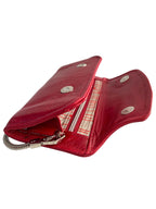 Red leather wallet with chain strap, open to show the champagne silk interior lining.
