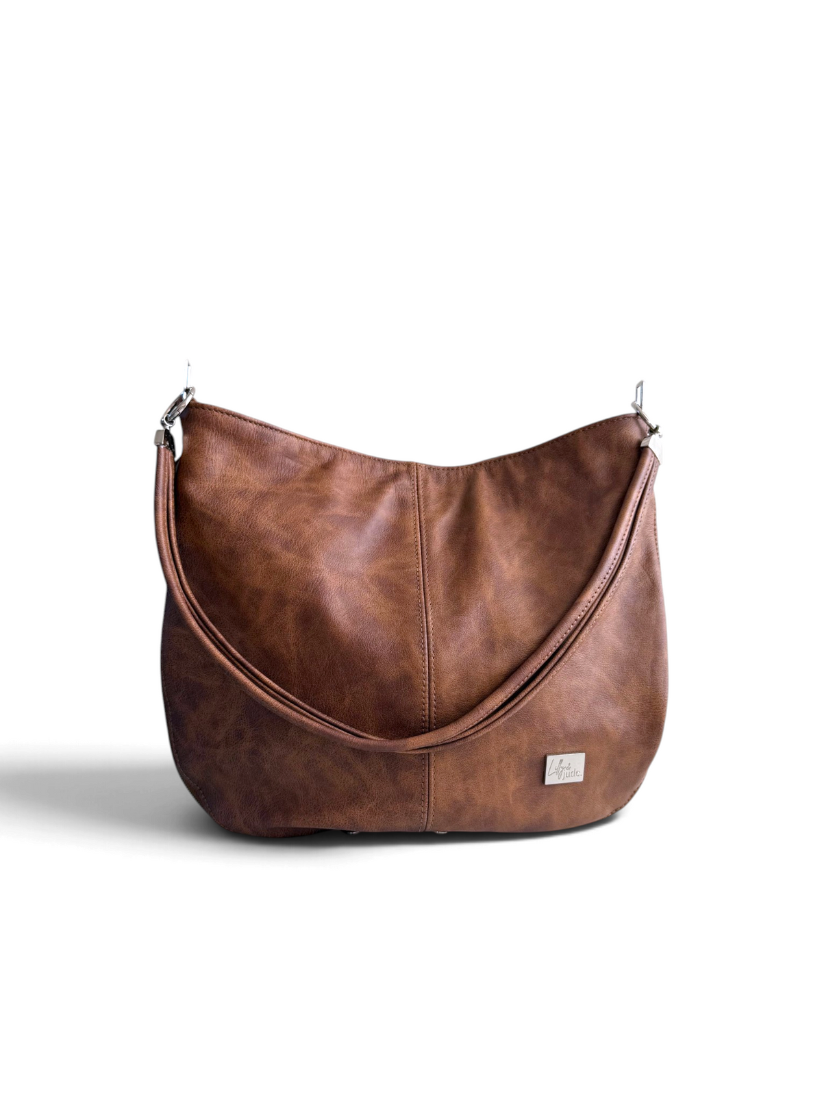 A brown leather hobo shoulder bag with a twin strand strap and a small silver brand plaque on the front, photographed on a clean white background.