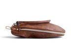 A brown leather handbag pouch shown in side profile, lying down on a clean white background.