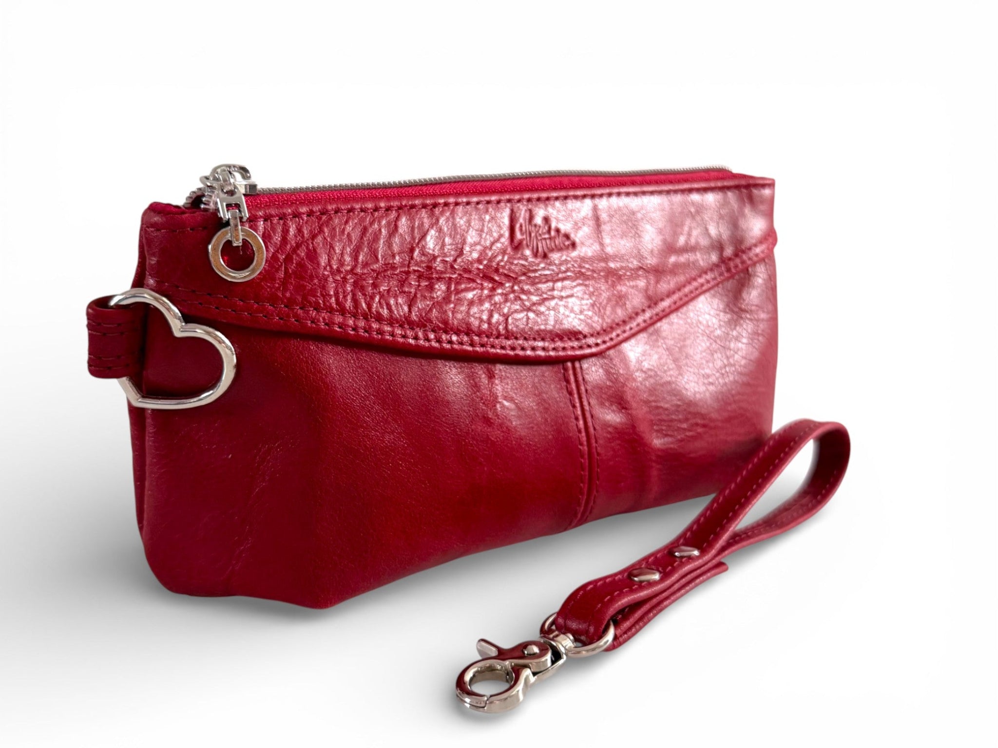 Red leather clutch bag with a strap on a white background