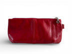 Red leather clutch bag with a zipper on a white background