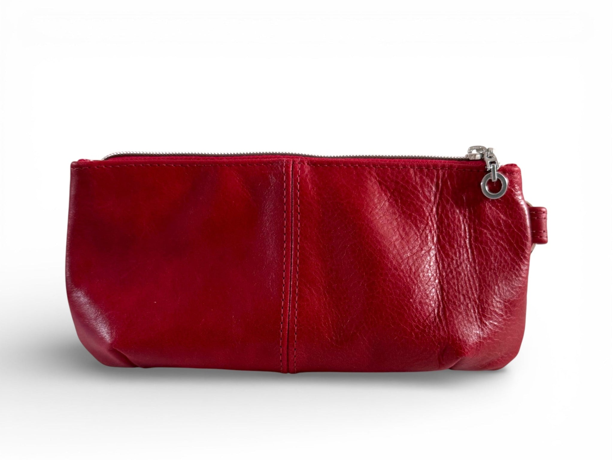 Red leather clutch bag with a zipper on a white background