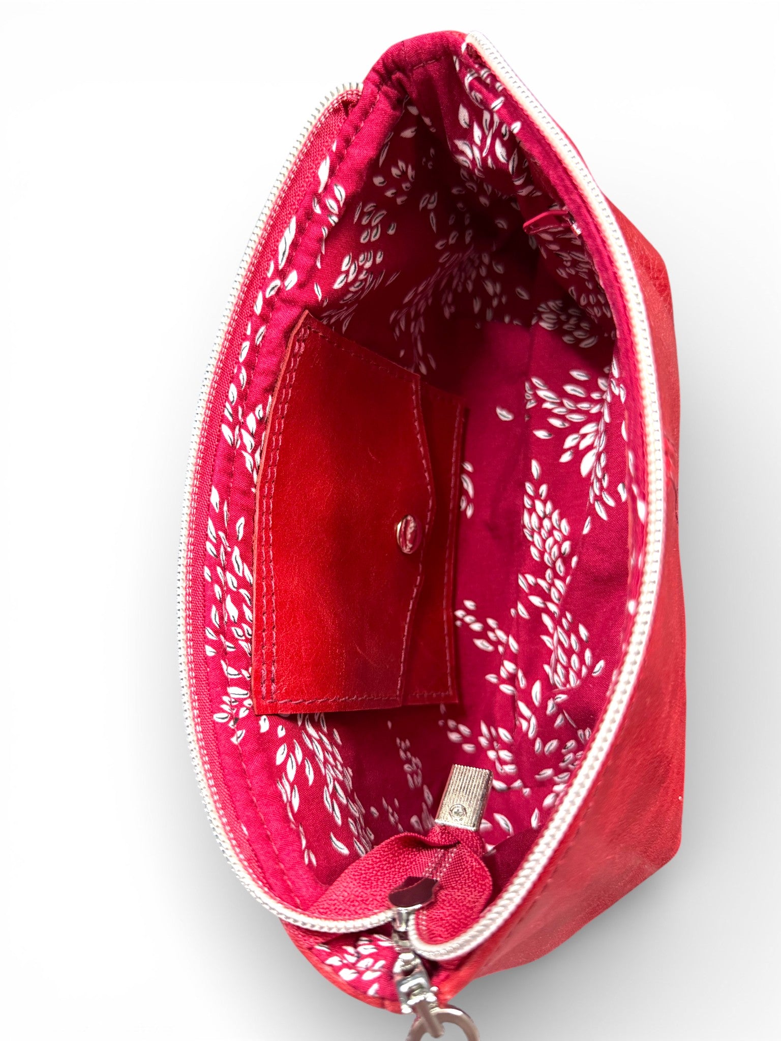 Red patterned pouch with a zipper on a white background