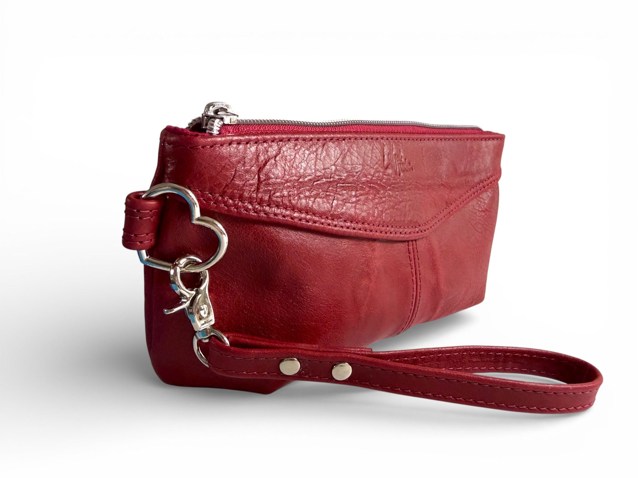 Red leather wristlet with a heart shaped keychain on a white background