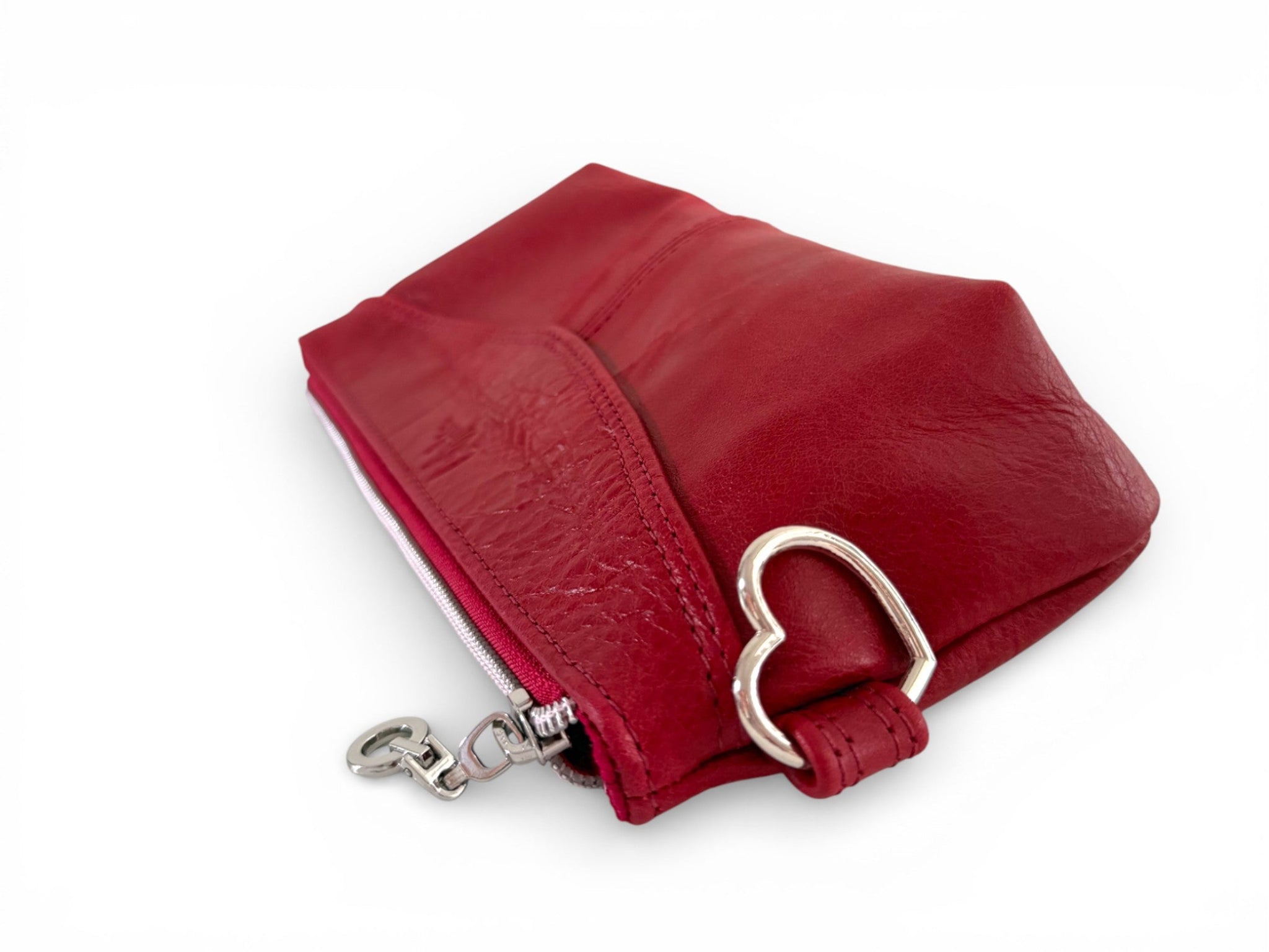 Red leather pouch with a silver heart shaped clasp on a white background