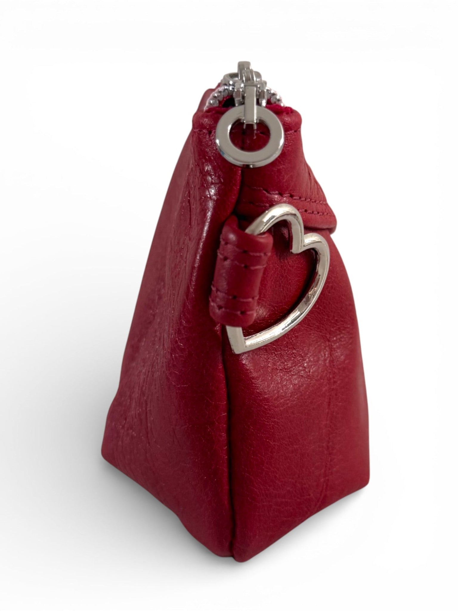 Red leather handbag with silver heart-shaped clasp on a white background