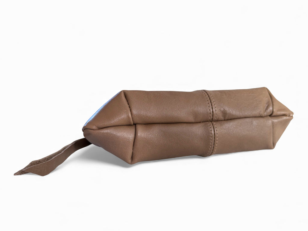 View of the bottom of the Ella wristlet clutch bag. A hand crafted in grey brown coloured leather pouch on a white background