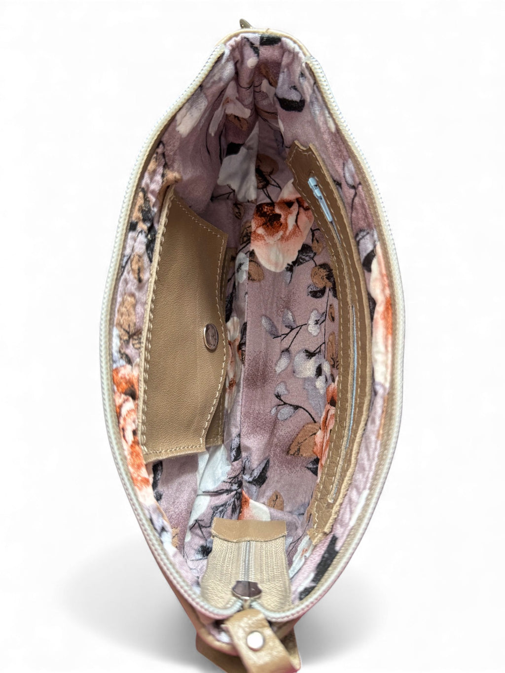 Interior view of the beige  leather Ella wristlet. The image shows the floral-patterned lining with a zipper pocket and integrated leather purse