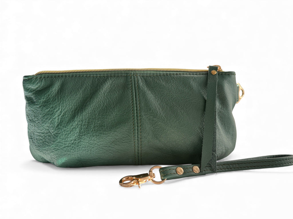 View of the back of the Ella, a green leather clutch with a strap on a white background